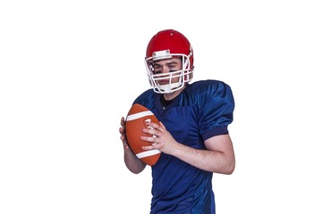 Serious american football player holding a ball