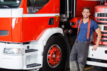 Confident Firefighter Leaning On Truck