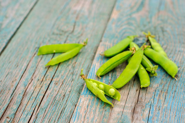 Ripe green peas in pod on shabby background