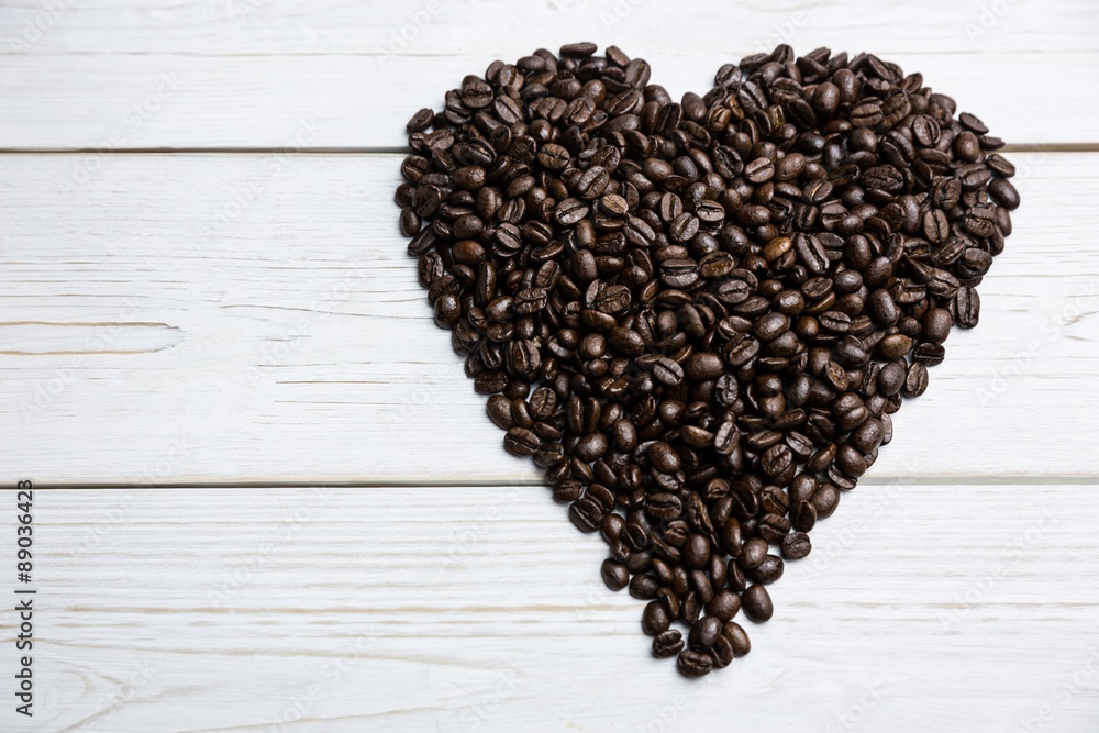 Poster coffee beans on a table in heart shape