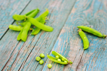 Ripe green peas in pod on shabby background