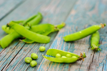 Ripe green peas in pod on shabby background