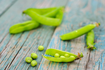 Ripe green peas in pod on shabby background