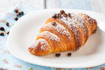 Croissant with coffee beans