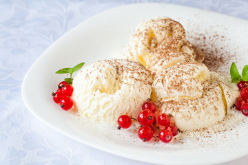 Vanilla ice cream with red currants and cocoa