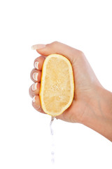 Young woman squeezing lemon