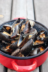 Steamed fresh mussels with wine in a pot.