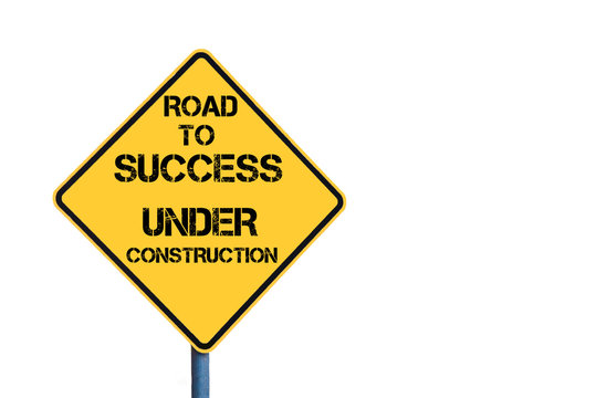 Yellow roadsign with Road To Success Under Construction message