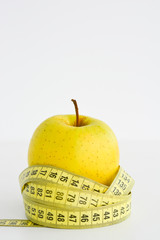 Apple and measuring tape suggesting diet concept