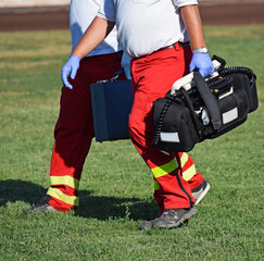 Fototapeta premium Ambulance staff with a defibrillator at the scene of a sport event