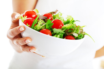 Salad bowl in woman hands