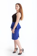 Fototapeta premium Beautiful woman in blue skirt and high heels posing, isolated on white background, full-length