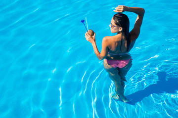 Girl standing in swim pool