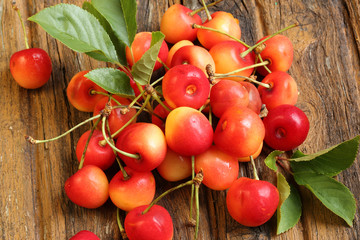 Fresh sweet cherries on old wooden background retro vintage