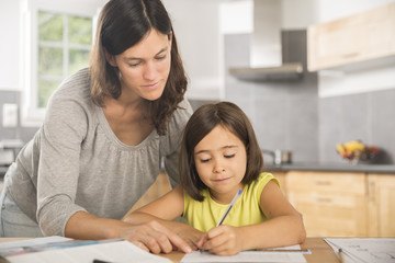 Mother and daughter doing homework together.