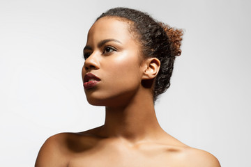 Young black woman in profile with bare shoulders