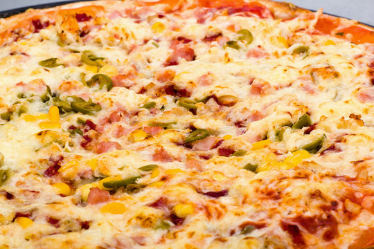 Closeup view of pizza with cheese and ham