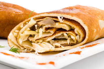 Stuffed pancakes on white close up