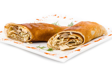 Stuffed pancakes on white close up
