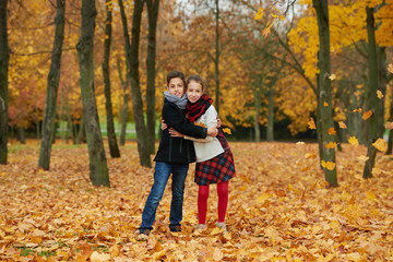 Fototapeta premium boy and girl in autumn park