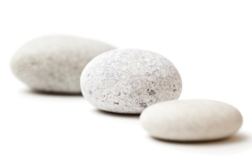 three gray spa stones isolated on white background