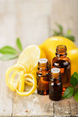 lemon essential oil and lemon fruit on the wooden board, (taken with tilt shift lens)