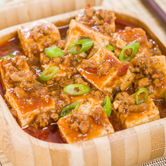 Mapo Tofu - Tofu and minced pork cooked with chili bean paste, fermented black beans, chili oil and Szechuan peppers, garnished with spring onions. 

