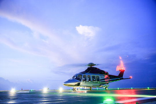 helicopter parking landing on offshore platform. Helicopter transfer crews or passenger to work in offshore oil and gas industry.Night flight training of Pilot and coordinate pilot.