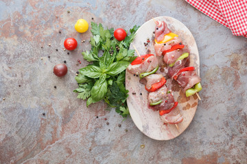 Meat skewers with vegetables in oil marinade,  top view