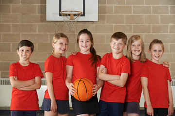 Fototapeta premium Portrait Of School Basketball Team In Gym