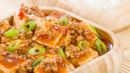 Mapo Tofu - Tofu and minced pork cooked with chili bean paste, fermented black beans, chili oil and Szechuan peppers, garnished with spring onions. Served with white steamed rice.
