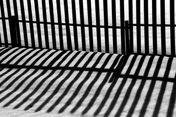 wooden fences with long shadows in the evening