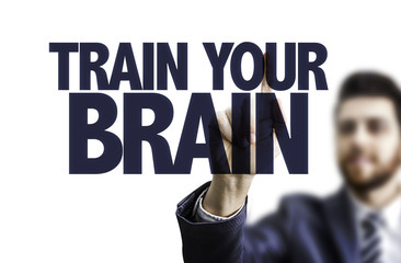 Business man pointing the text: Train Your Brain