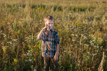 Naklejka na ściany i meble boy talking on mobile phone