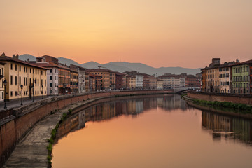 Fototapeta na wymiar Sunrise on Arno River, Pisa, Tuscany.