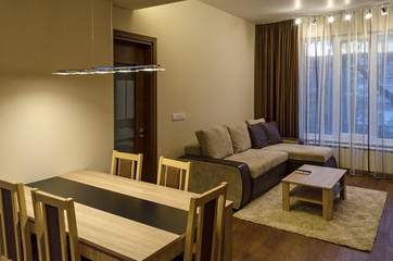 Living room with dining-table in renovated apartment