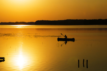 Fototapeta na wymiar Silhouette of kayak on lake 