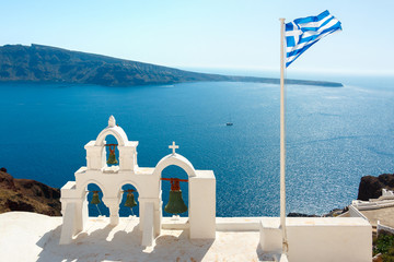 Bell towers and Greek flag on Santorini