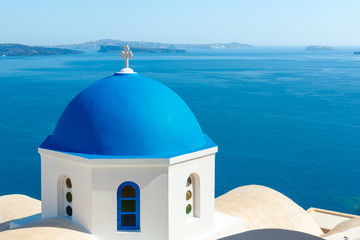 Greek church with blue dome in Oia, Santorini