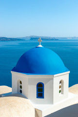 Fototapeta na wymiar Greek church with blue dome in Oia, Santorini