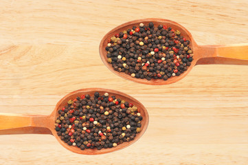 spice cumin pepper in wooden spoon over wooden background