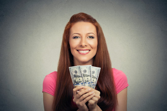 happy excited successful young business woman holding money dollar bills