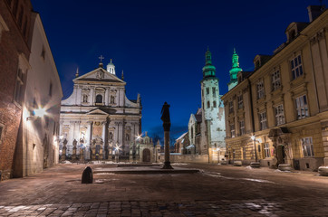 Krakow, Poland, night view of Saint Mary Magdalene square with catholic churches of Saints Peter and Paul and Saint Andrew