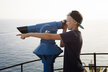 Teenager surveillances through telescope