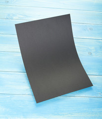 Blank flyer poster on wooden background to replace your design