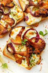 Toast with chanterelle mushrooms, onion,  cheese and herbs