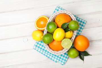 Citrus fruits in basket. Oranges, limes and lemons