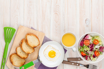 Healthy breakfast with fried egg, toasts and salad