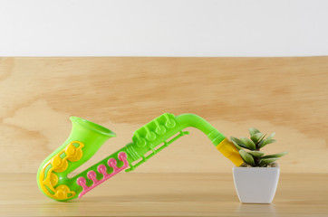 Plant and toy saxophone