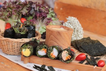 Vegetable salad wrapped with seaweed into spring rolls.